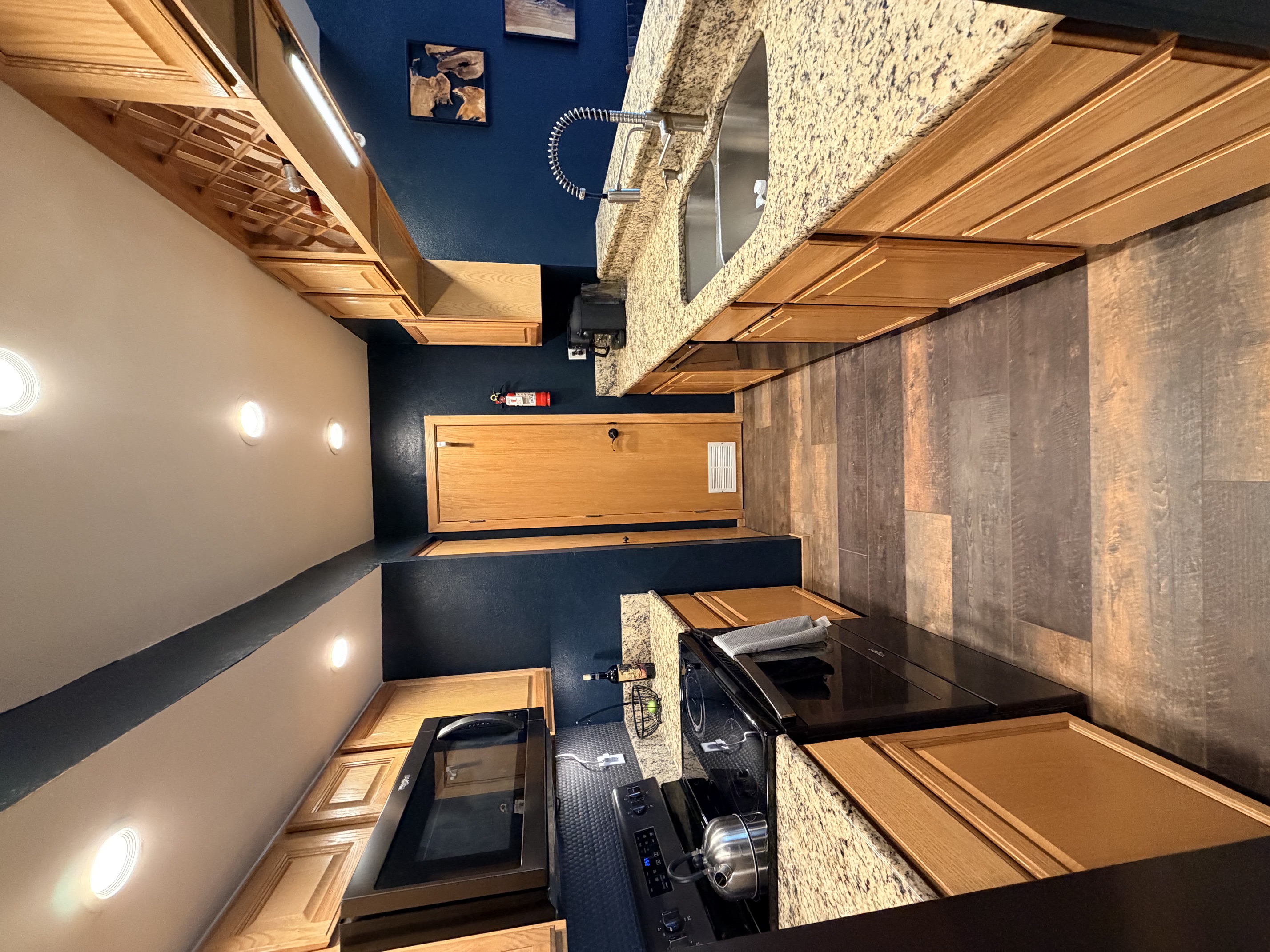 Galley kitchen with granite countertops at The Eyrie