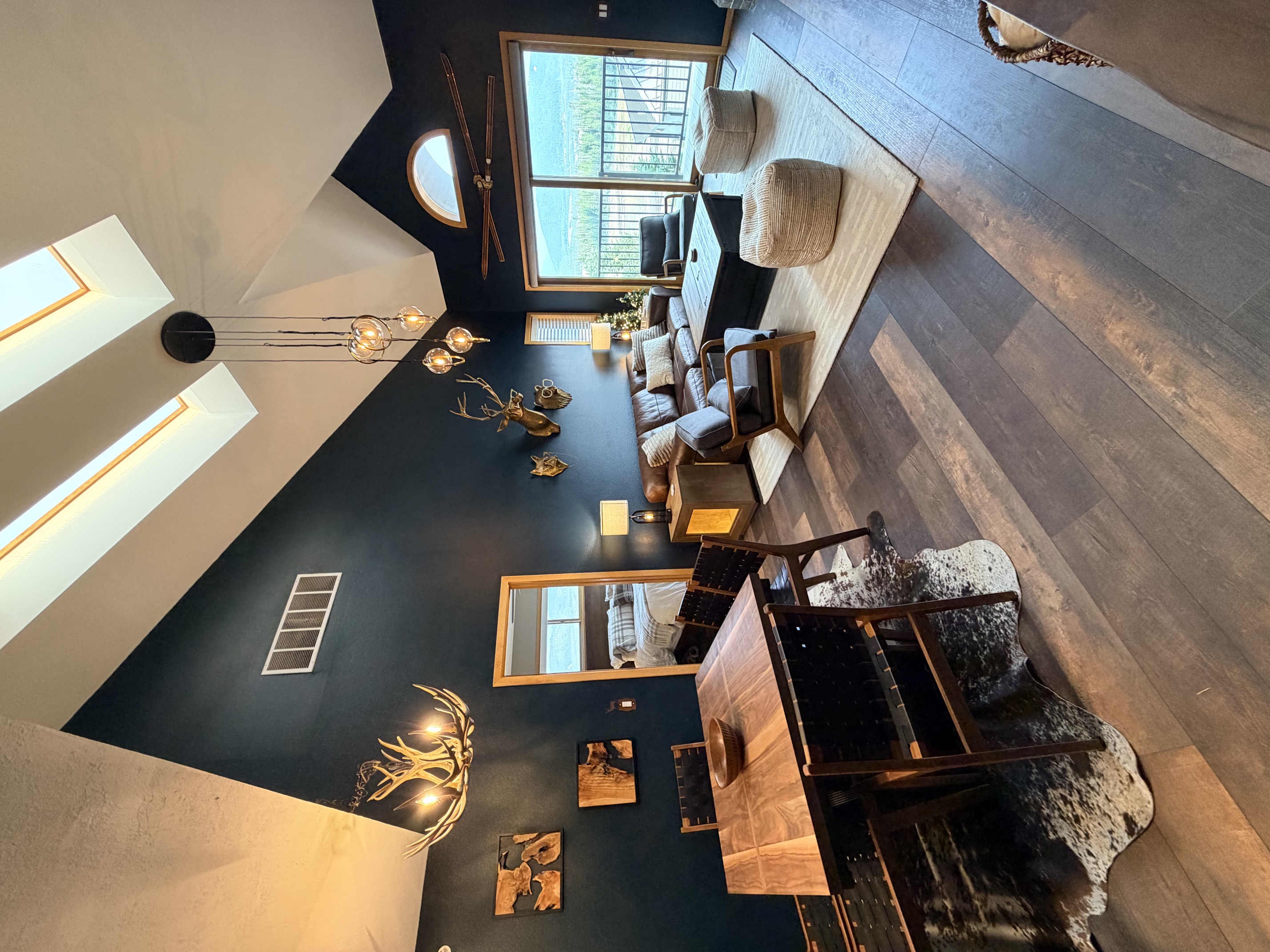 Vaulted living room with skylights and mountain views at The Eyrie